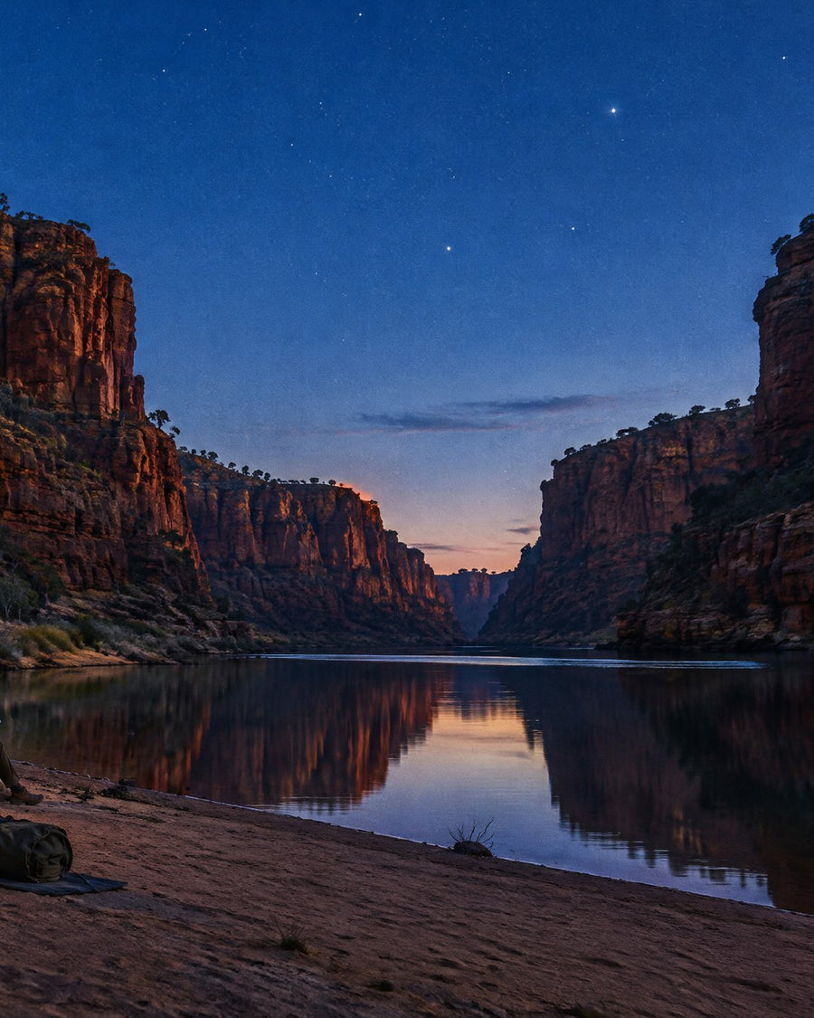 Red Kimberley gorge walls reflected in a still river under a starry dusk sky
